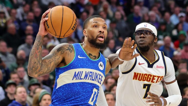 MILWAUKEE, WISCONSIN - FEBRUARY 12: Damian Lillard #0 of the Milwaukee Bucks drives around Reggie Jackson #7 of the Denver Nuggets during a game at Fiserv Forum on February 12, 2024 in Milwaukee, Wisconsin. NOTE TO USER: User expressly acknowledges and agrees that, by downloading and or using this photograph, User is consenting to the terms and conditions of the Getty Images License Agreement. (Photo by Stacy Revere/Getty Images)