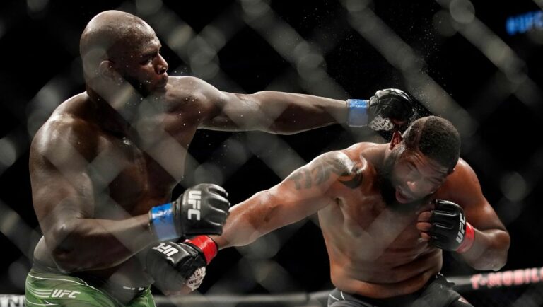 Jairzinho Rozenstruik, left, hits Curtis Blaydes during a heavyweight mixed martial arts bout at UFC 266.