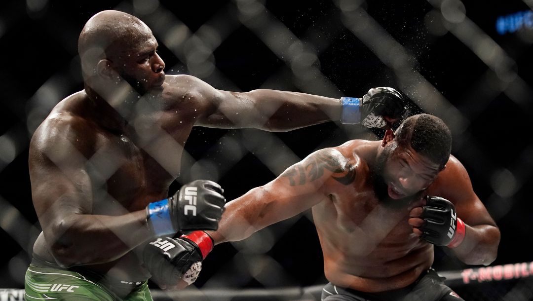 Jairzinho Rozenstruik, left, hits Curtis Blaydes during a heavyweight mixed martial arts bout at UFC 266.