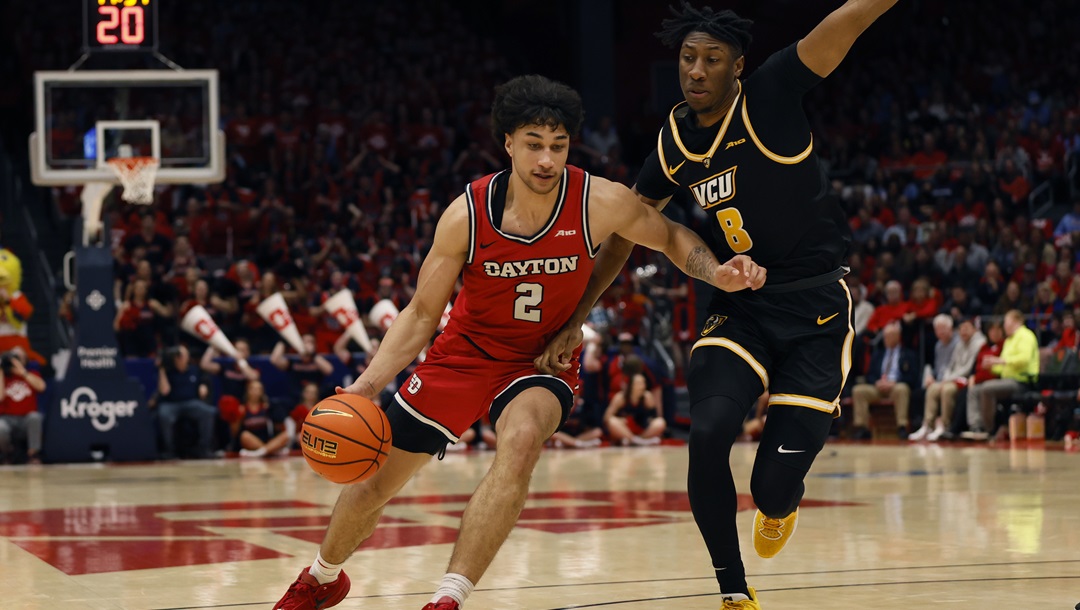 Dayton's Nate Santos, left, drives to the basket against Virginia Commonwealth's Michael Belle, right, during the second half of an NCAA college basketball game Friday, March 8, 2024, in Dayton, Ohio.