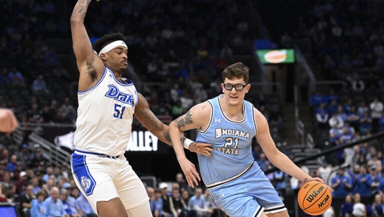 Drake's Darnell Brodie (51), left, defends against Indiana State's Robbie Avila during the first half of the championship game in the Missouri Valley Conference NCAA basketball tournament Sunday, March 10, 2024, in St. Louis.