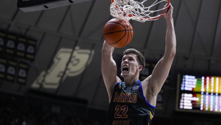 Morehead State guard Riley Minix (22) gets a basket on a dunk against Purdue during the first half of an NCAA college basketball game in West Lafayette, Ind., Friday, Nov. 10, 2023. This 6-7 graduate student was the Ohio Valley Conference player of the year at Morehead State after transferring from NAIA program Southeastern (Florida).