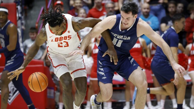 New Mexico center Nelly Junior Joseph, left, and Nevada forward Nick Davidson chase a loose ball during the first half of an NCAA basketball game, Sunday, Jan. 28, 2024, in Albuquerque, N.M.