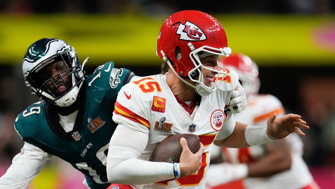 Kansas City Chiefs quarterback Patrick Mahomes (15) escapes the grasp of Philadelphia Eagles linebacker Josh Sweat (19) during the first half of the NFL Super Bowl 59 football game, Sunday, Feb. 9, 2025, in New Orleans. (AP Photo/George Walker IV)