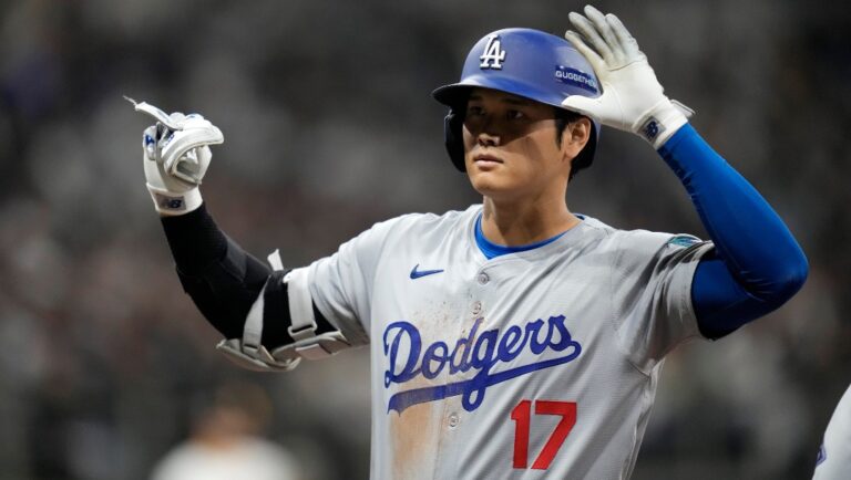 Los Angeles Dodgers designated hitter Shohei Ohtani gestures after hitting a single during the third inning of an opening day baseball game against the San Diego Padres at the Gocheok Sky Dome in Seoul, South Korea Wednesday, March 20, 2024, in Seoul, South Korea.