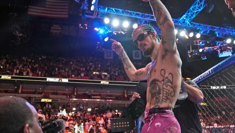 Sean O'Malley celebrates after retaining his UFC bantamweight title against Marlon Vera at the UFC 299 mixed martial arts event.