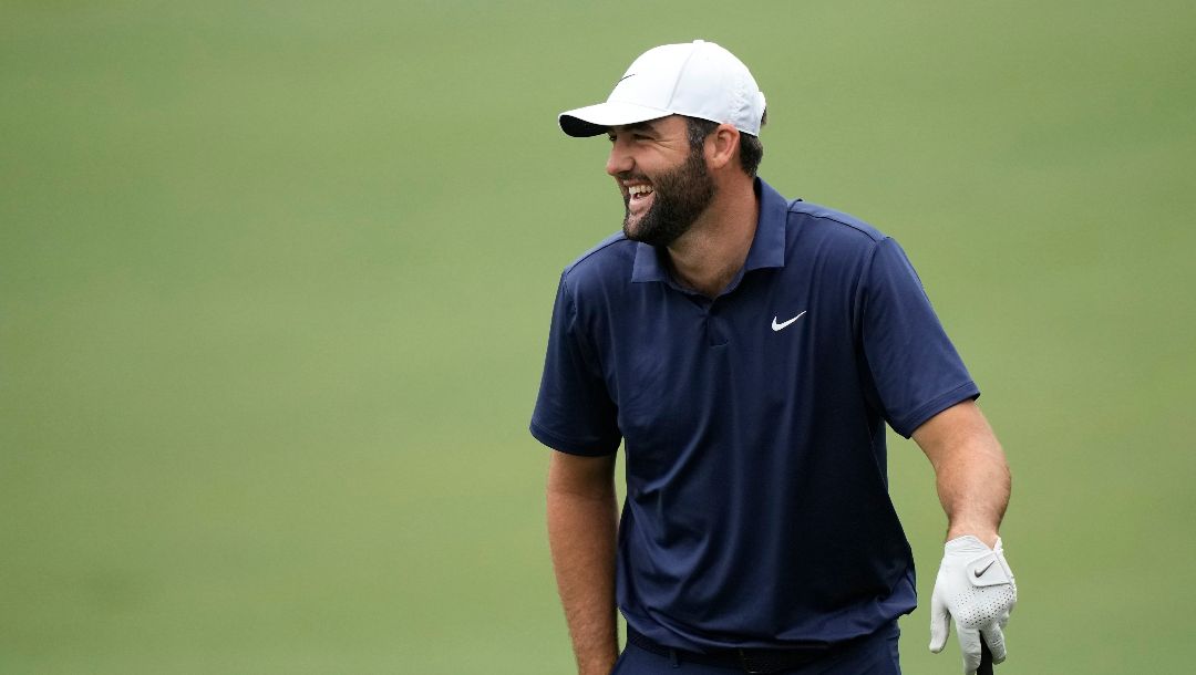 Scottie Scheffler laughs on the driving range during a practice round in preparation for the Masters golf tournament at Augusta National Golf Club Tuesday, April 9, 2024, in Augusta, Ga.