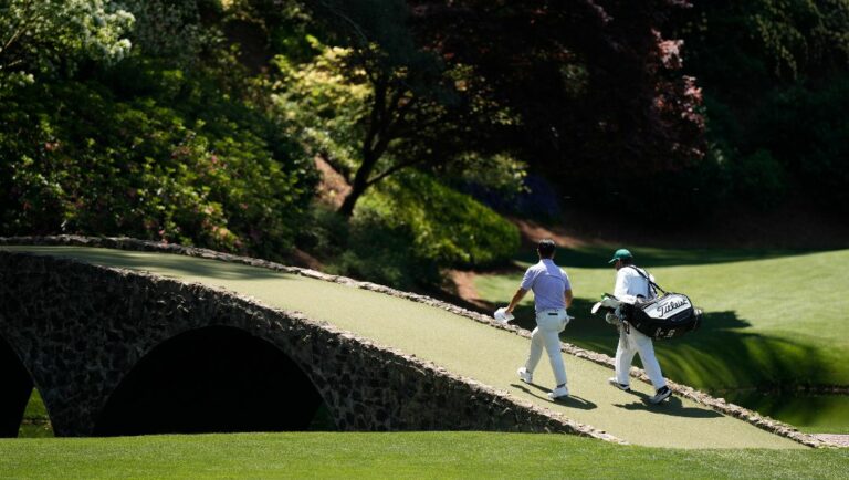 Tom Kim, of South Korea, walks to the 12th green during a practice round in preparation for the Masters golf tournament at Augusta National Golf Club Sunday, April 7, 2024, in Augusta, Ga.