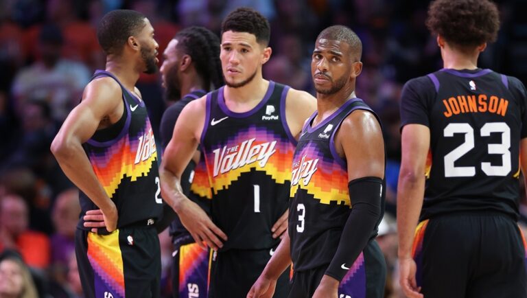 Chris Paul #3 of the Phoenix Suns stands on the court with Mikal Bridges #25, Devin Booker #1 and Cameron Johnson #23 during the first half of Game Seven of the Western Conference Second Round NBA Playoffs at Footprint Center on May 15, 2022 in Phoenix, Arizona. The Mavericks defeated the Suns 123-90.