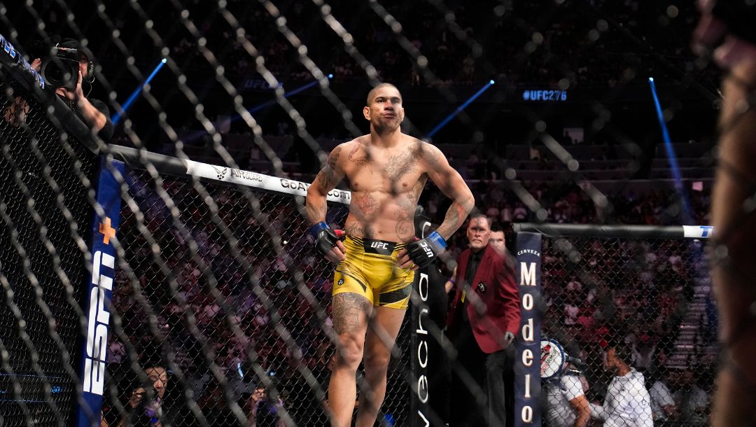 Alex Pereira, center, reacts after winning a middleweight bout against Sean Strickland during the UFC 276 mixed martial arts event.