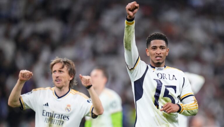 Real Madrid's Jude Bellingham, right, and Real Madrid's Luka Modric celebrate at the end of the Champions League semifinal second leg soccer match between Real Madrid and Bayern Munich at the Santiago Bernabeu stadium in Madrid, Spain, Wednesday, May 8, 2024.