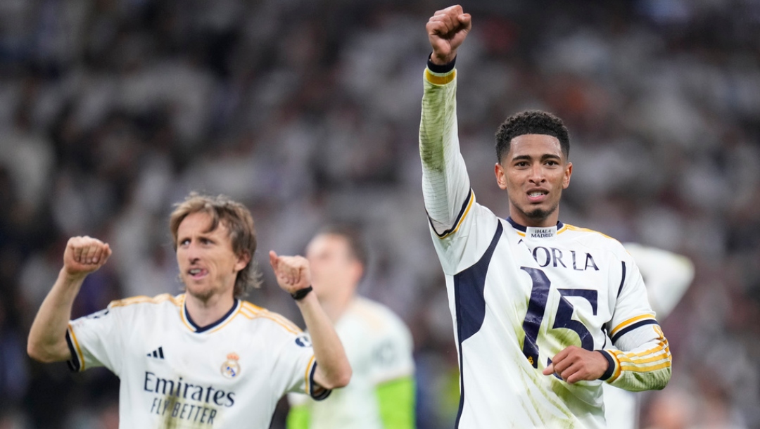 Real Madrid's Jude Bellingham, right, and Real Madrid's Luka Modric celebrate at the end of the Champions League semifinal second leg soccer match between Real Madrid and Bayern Munich at the Santiago Bernabeu stadium in Madrid, Spain, Wednesday, May 8, 2024.