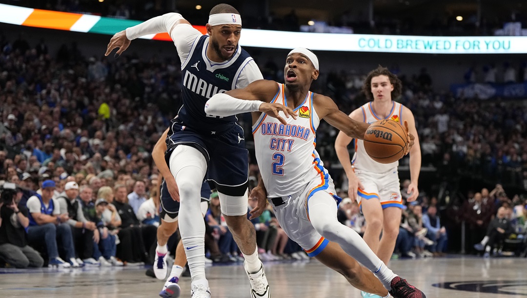 Shai Gilgeous-Alexander #2 of the Oklahoma City Thunder is defended by Daniel Gafford #21 of the Dallas Mavericks during the first half at American Airlines Center on February 10, 2024 in Dallas, Texas.
