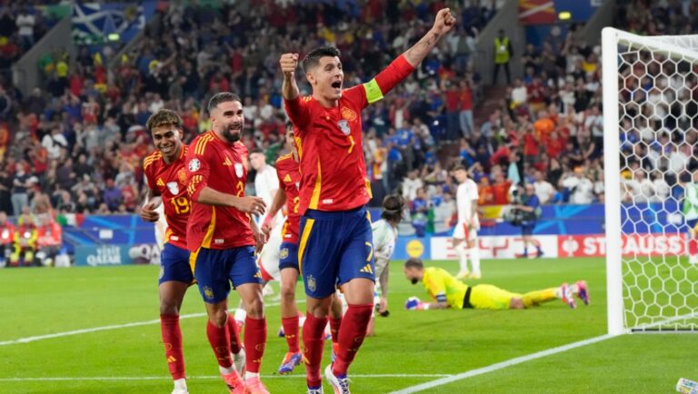 Spain's Alvaro Morata (7) ) Dani Carvajal, center, and Lamine Yamal (19) celebrate after an own goal by Italy's Riccardo Calafiori during a Group B match between Spain and Italy at the Euro 2024 soccer tournament in Gelsenkirchen, Germany, Thursday, June 20, 2024.