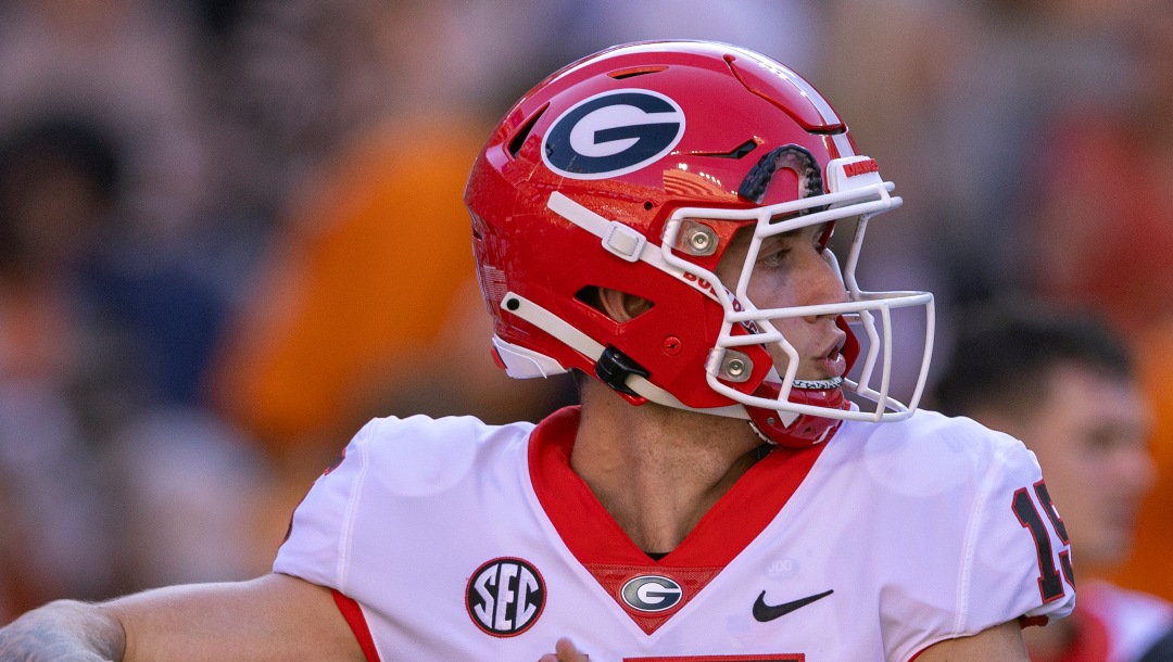 Georgia quarterback Carson Beck (15) throws to a receiver during warmups before an NCAA college football game against Tennessee, Saturday, Nov. 18, 2023, in Knoxville, Tenn. (AP Photo/Wade Payne)