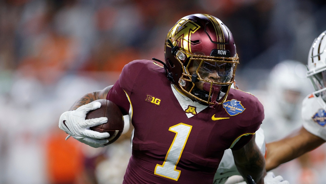 Minnesota running back Darius Taylor (1), left, rushes against Bowling Green linebacker Cashius Howell (0), right, and Bowling Green safety Darius Lorfils (9), rear, during the first half of the Quick Lane Bowl NCAA college football game, Tuesday, Dec. 26, 2023, in Detroit. (AP Photo/Al Goldis)