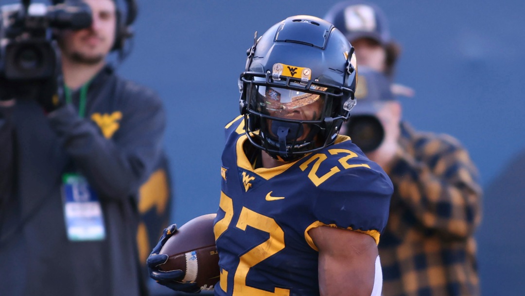 West Virginia's (22) Jaheim White scores a receiving touchdown during the first half of an NCAA college football game against Cincinnati, Saturday, Nov. 18, 2023, in Morgantown, W.Va. (AP Photo/Chris Jackson)