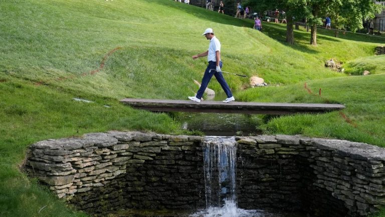 Scottie Scheffler crosses a bridge to the 17th green during the second round of the Memorial golf tournament, Friday, June 7, 2024, in Dublin, Ohio.