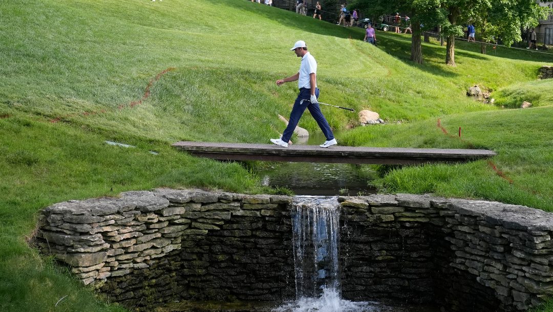 Scottie Scheffler crosses a bridge to the 17th green during the second round of the Memorial golf tournament, Friday, June 7, 2024, in Dublin, Ohio.