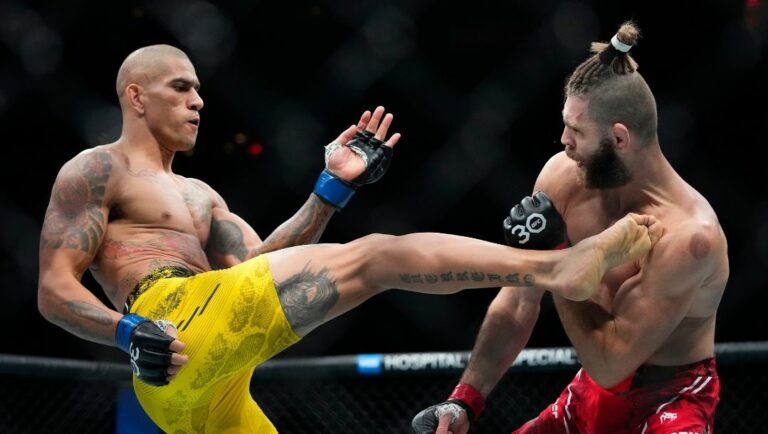 Brazil's Alex Pereira, left, kicks Czech Republic's Jirí Procházka during the second round of a light heavyweight title bout.