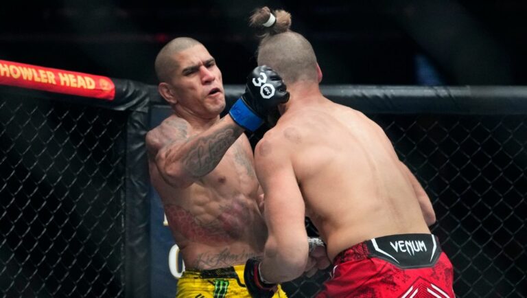Brazil's Alex Pereira, left, punches Czechia's Jirí Procházka during the second round of a light heavyweight title bout.