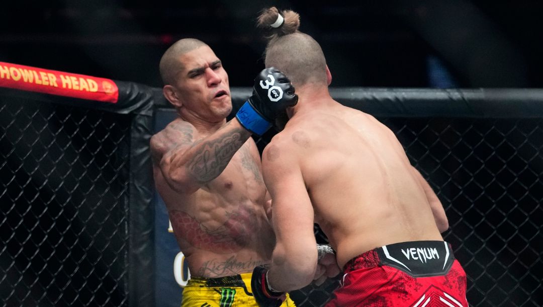 Brazil's Alex Pereira, left, punches Czechia's Jirí Procházka during the second round of a light heavyweight title bout.