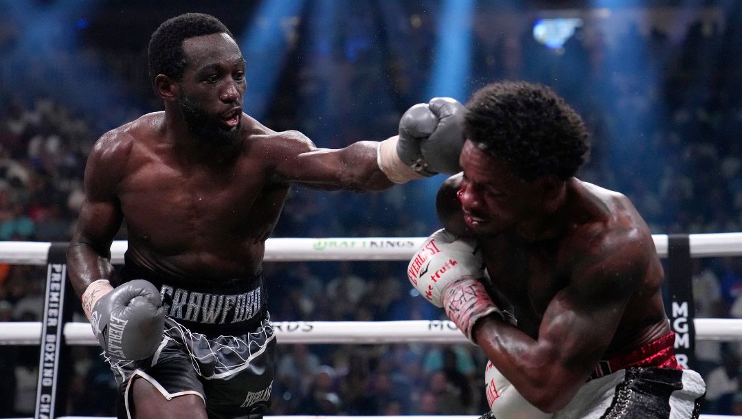 Errol Spence Jr., right, and Terence Crawford fight during their undisputed welterweight championship boxing match.