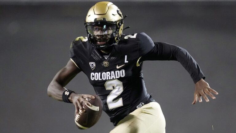 Colorado quarterback Shedeur Sanders (2) is pursued by Stanford linebacker Spencer Jorgensen (10) in the first half of an NCAA college football game Friday, Oct. 13, 2023, in Boulder, Colo.