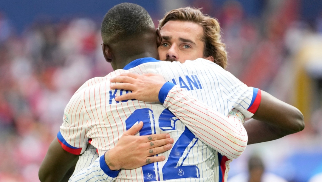 Randal Kolo Muani and Antoine Griezmann of France celebrate their side's first goal during a round of sixteen match between France and Belgium at the Euro 2024 soccer tournament in Duesseldorf, Germany, Monday, July 1, 2024.