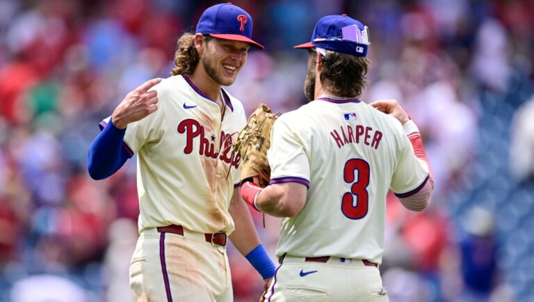 Philadelphia Phillies' Alec Bohm, left, and Bryce Harper, right, celebrate after a baseball game against the Arizona Diamondbacks, Sunday, June 23, 2024, in Philadelphia.