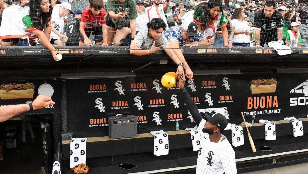 Fans get autographs from Chicago White Sox designated hitter Luis Robert Jr. before the baseball game between the Chicago White Sox and the Los Angeles Dodgers, Wednesday, June 26, 2024, in Chicago.
