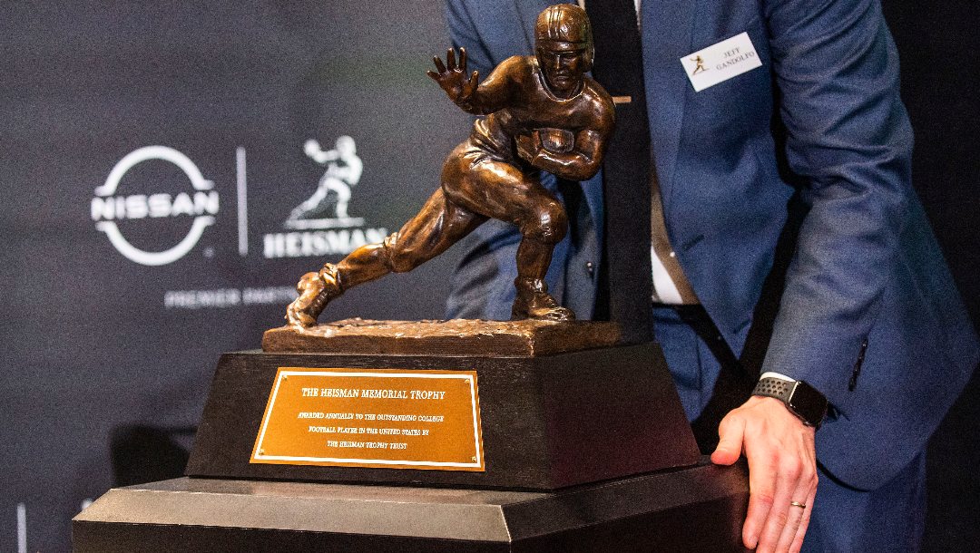Jeff Gandolfo organizes the Heisman trophy before the award ceremony, Saturday, Dec. 9, 2023, in New York.