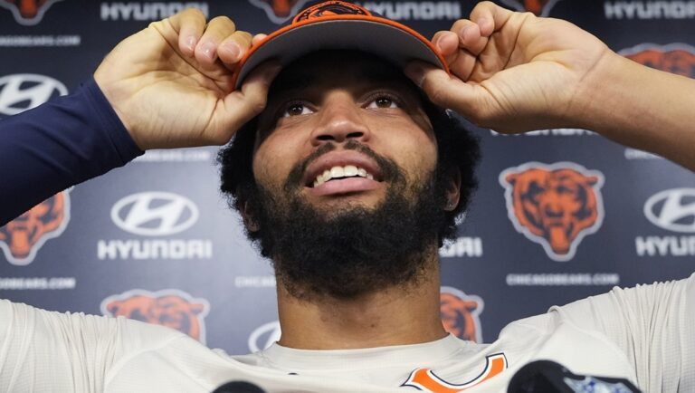 Chicago Bears quarterback Caleb Williams adjusts his hat as he attends a news conference after practice at the NFL football team's mandatory minicamp in Lake Forest, Ill., Thursday, June 6, 2024.