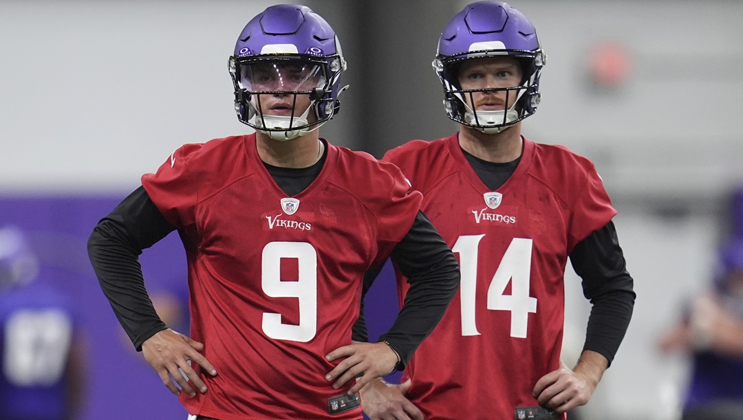 Minnesota Vikings quarterbacks J.J. McCarthy (9) and Sam Darnold (14) stand on the field during an NFL football practice in Eagan, Minn., Tuesday, May 21, 2024.