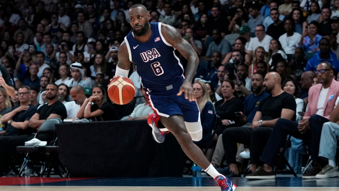 Team USA's LeBron James drives against Australia during the USA Basketball Showcase in Abu Dhabi, United Arab Emirates, Monday, July 15, 2024.