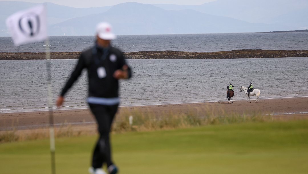 Police on horseback patrol the beach near the fifth hole at the British Open Golf Championships at Royal Troon golf club in Troon, Scotland, Tuesday, July 16, 2024.
