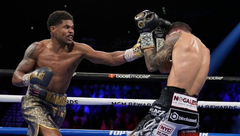 Shakur Stevenson, left, throws a punch at Oscar Valdez during the WBC-WBO junior lightweight title boxing bout Saturday.