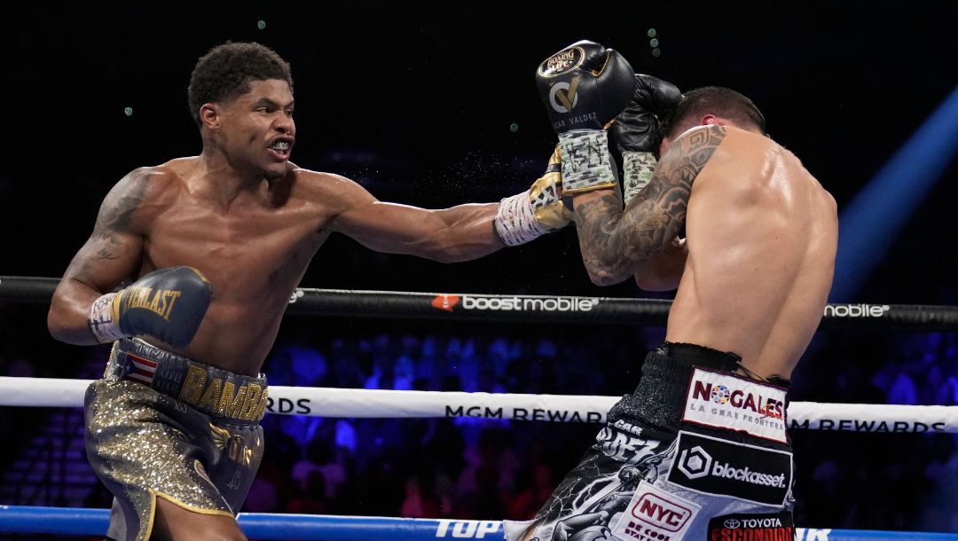 Shakur Stevenson, left, throws a punch at Oscar Valdez during the WBC-WBO junior lightweight title boxing bout Saturday.