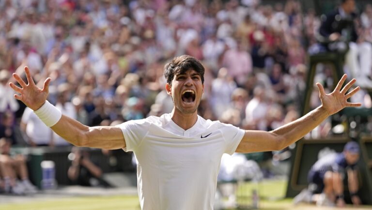 Carlos Alcaraz of Spain celebrates after defeating Novak Djokovic of Serbia in the men's singles final at the Wimbledon tennis championships in London, Sunday, July 14, 2024.