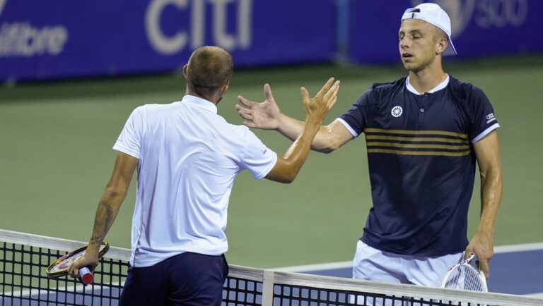 Daniel Evans, of Britain, left, shakes hands with Tallon Griekspoor, of the Netherlands, after Evans won the men's singles final of the DC Open tennis tournament Sunday, Aug. 6, 2023, in Washington.