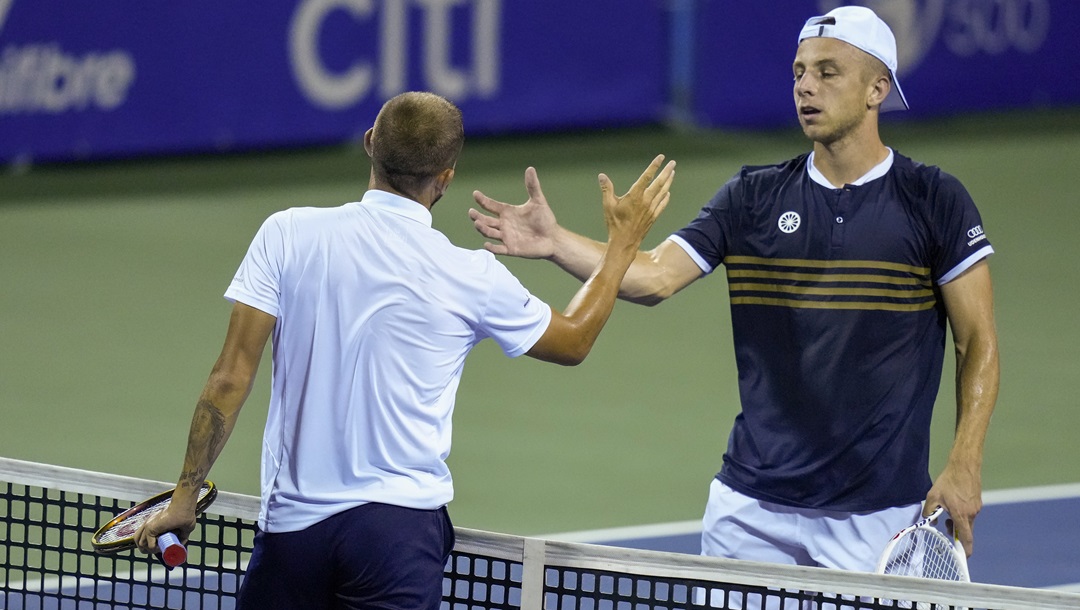 Daniel Evans, of Britain, left, shakes hands with Tallon Griekspoor, of the Netherlands, after Evans won the men's singles final of the DC Open tennis tournament Sunday, Aug. 6, 2023, in Washington.