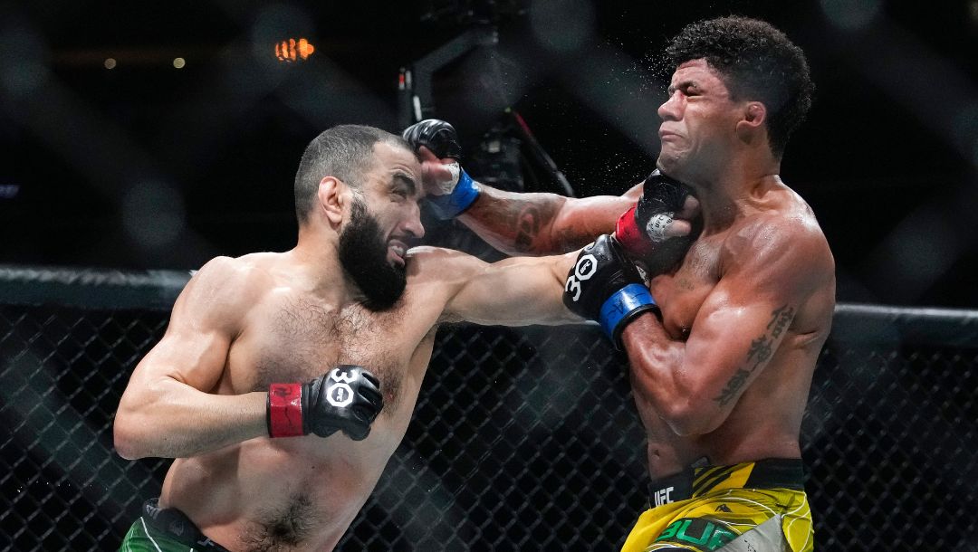 Belal Muhammad, left, punches Brazil's Gilbert Burns during the fifth round of a welterweight bout at the UFC 288.