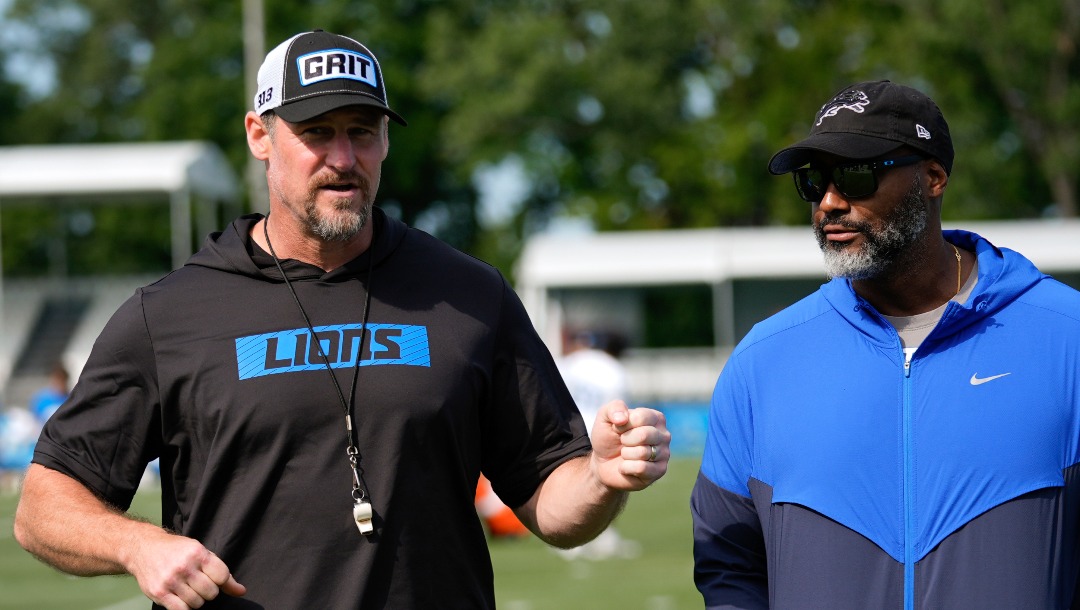 Detroit Lions head coach Dan Campbell, left, talks with general manager Brad Holmes after an NFL football practice in Allen Park, Mich., Thursday, July 25, 2024. (AP Photo/Paul Sancya)