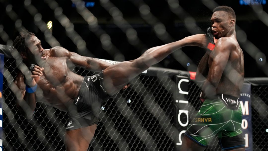 Jared Cannonier, left, kicks Israel Adesanya in a middleweight title bout during the UFC 276 mixed martial arts event Saturday.