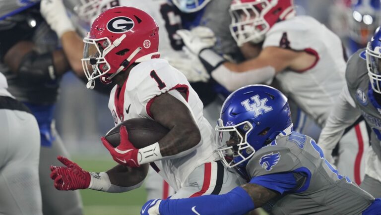 Georgia running back Trevor Etienne (1) is tackled by Kentucky defensive back Zion Childress (11) during the first half of an NCAA college football game, Saturday, Sept. 14, 2024, in Lexington, Ky.