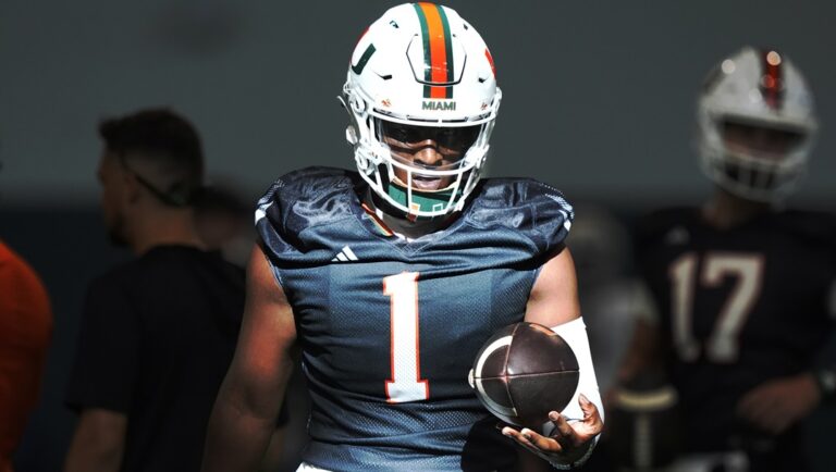 Miami quarterback Cam Ward (1) holds the ball during NCAA college football practice, Wednesday, July 31, 2024, in Coral Gables, Fla.