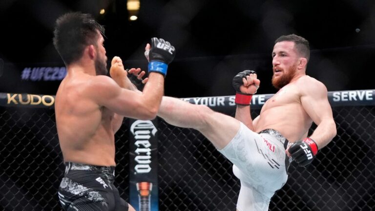 Merab Dvalishvili, right, throws a kick at Henry Cejudo during their bantamweight bout at the UFC 298 mixed martial arts event.