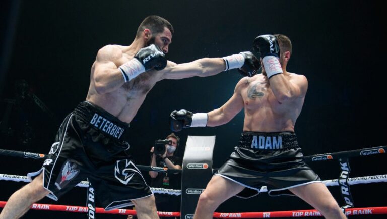 Russia's Artur Beterbiev, left, hits Germany's Adam Deines during the WBC and IBF light heavyweight title boxing match.