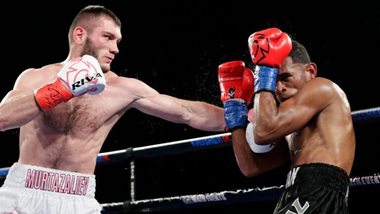 Russia's Bakhram Murtazaliev punches Colombia's Carlos Galvan, right, during the fourth round of a super welterweight title.