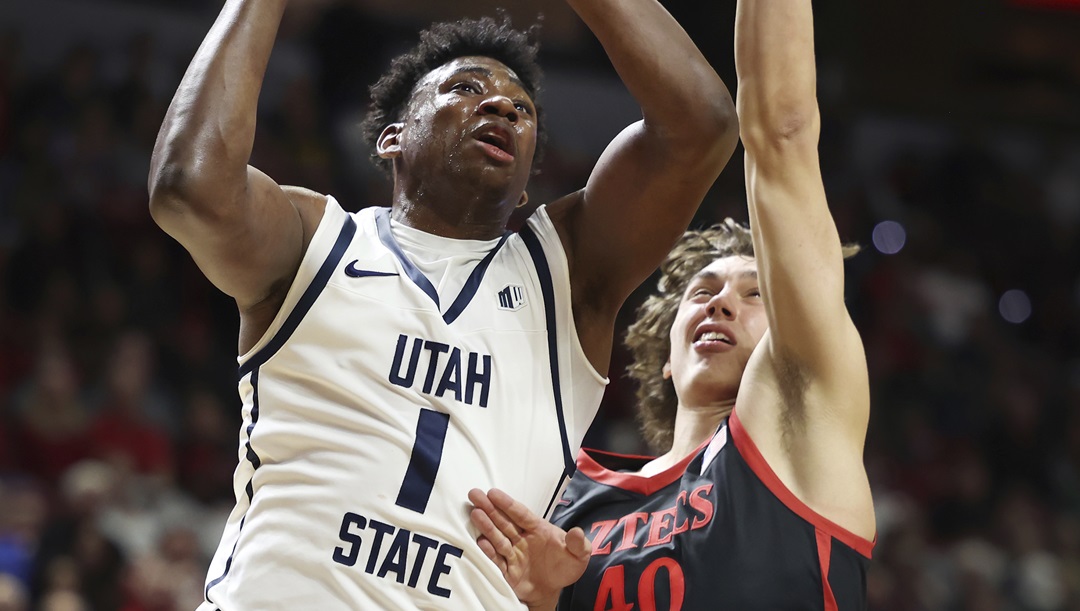 Utah State forward Great Osobor (1) goes up for a shot next to San Diego State forward Miles Heide (40) during the first half of an NCAA college basketball game in the semifinals of the Mountain West Conference men's tournament Friday, March 15, 2024, in Las Vegas. San Diego State won 86-70.